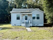 Gray one-story house with front porch and small yard at 2642 Ferrara Dr, North Charleston, SC 29405