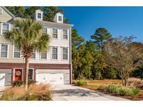 Two-story townhome with a two-car garage and nicely landscaped front yard at 3532 Claremont St, Mount Pleasant, SC 29466