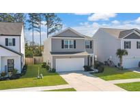 Two-story house with gray siding, white garage door, and landscaped lawn at 314 Black Birch Dr, Summerville, SC 29486