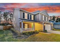 Two-story house with brick and siding, showcasing a welcoming front porch at 319 Deep River Rd, Summerville, SC 29486