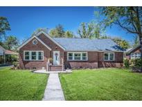 Brick home with gray roof, landscaped lawn, and walkway at 118 Carter, Walterboro, SC 29488