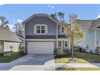 Two-story gray house with white shutters, a two-car garage, and a landscaped lawn at 496 Oak View Way, Summerville, SC 29483