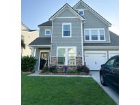 Two-story house with gray siding, stone accents, and a landscaped lawn at 1011 Mossy Rock Dr, Summerville, SC 29485