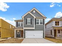 Two-story gray house with white garage door and brown front door at 422 Grove End Rd, Moncks Corner, SC 29461