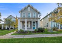 Charming two-story home with gray siding, a front porch, and well-manicured lawn at 313 Oakbend St, Summerville, SC 29486