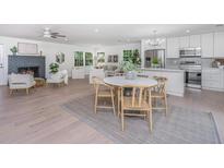 Open concept kitchen and dining area, featuring stainless steel appliances and an island at 738 Olney Rd, Charleston, SC 29414
