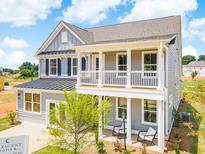 Two-story gray house with a front porch, white columns, and a metal roof at 765 Maynard Ln, Summerville, SC 29486