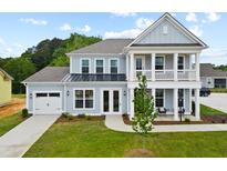 Two-story house with light blue siding, white trim, and a front porch at 787 Maynard Ln, Summerville, SC 29486