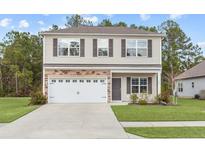 Two-story house with a two-car garage and stone accents at 104 Belgian Ct, Summerville, SC 29486