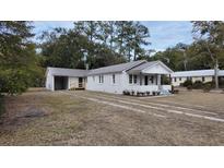 Charming bungalow with metal roof, newly landscaped yard and driveway at 220 Thompson St, Walterboro, SC 29488