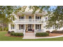 Two-story house with wraparound porch and landscaped yard at 1129 Plantation Overlook Dr, Moncks Corner, SC 29461