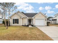 Beige house with a white garage door and manicured lawn at 116 Hearthstone Cir, Goose Creek, SC 29445