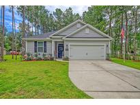 Gray house with 2-car garage, landscaping, and American flag at 119 Osage Way, Summerville, SC 29483