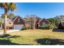 Brick home with attached garage and manicured lawn at 1441 Waterside Ct, Mount Pleasant, SC 29464