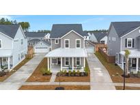 Two-story Craftsman home with a metal roof and front porch at 282 Woodland Oak Way, Summerville, SC 29485