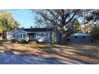 Charming gray house with a detached garage and mature trees at 412 Live Oak St, Walterboro, SC 29488