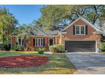 Brick home with a two-car garage and nicely landscaped yard at 1358 Hidden Lakes Dr, Mount Pleasant, SC 29464