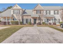 Two-story townhouses with neutral siding, gray roofs, and manicured lawns at 140 Black River Dr, Summerville, SC 29485