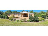 Ranch-style brick home with landscaped yard and fenced area at 3112 Santee River Rd, Saint Stephen, SC 29479