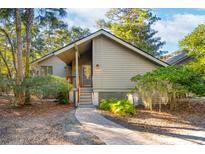 Charming one-story home with a landscaped yard and walkway at 456 Vetch Ct, Kiawah Island, SC 29455