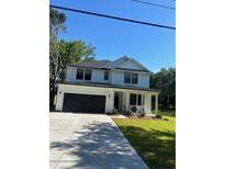 Charming two-story home with white siding, black roof, and a welcoming front porch at 1289 Hamlin Rd, Mount Pleasant, SC 29466