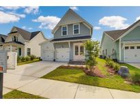 Charming 2-story home with a gray exterior, pink door, and 2-car garage at 368 Trailmore Ln, Summerville, SC 29486