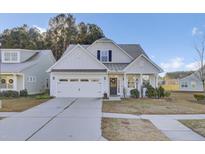 Two-story house with white siding, gray roof, and a two-car garage at 373 Whispering Breeze Ln, Summerville, SC 29486
