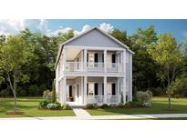 Charming two-story home with a welcoming front porch and lush landscaping at 1445 Clay Field Trl, Summerville, SC 29485
