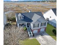 Charming two-story home with a two-car garage, brick facade, and a view of the marsh at 359 Clayton Dr, Charleston, SC 29414