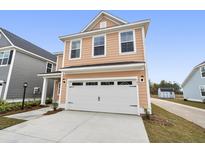 Peach-colored two-story home with a white garage door and a concrete driveway at 771 Opal Wing St, Moncks Corner, SC 29461