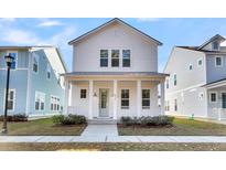 Charming white two-story home with a covered front porch and landscaped yard at 206 W Respite Ln, Summerville, SC 29483