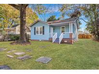 Charming blue cottage with white trim, front porch, and large yard at 2675 Houston St, North Charleston, SC 29405