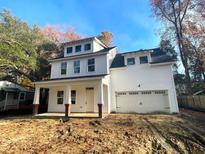 Charming two-story home with white siding, brick accents, and attached garage at 518 Fleming Rd, Charleston, SC 29412