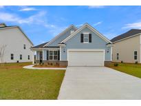Charming blue two-story home with a brick and siding facade and attached garage at 112 Crosscut Ln, Summerville, SC 29486