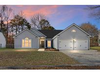 Gray house with two-car garage and landscaped lawn at 207 Thomaston Ave, Summerville, SC 29485