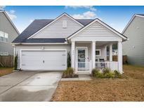 Charming one-story house with a front porch and attached garage at 356 Garden Lily Ln, Summerville, SC 29485