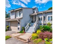 Inviting light gray home with landscaped gardens, and a spacious front porch at 668 Harbor Creek Place # 34, Charleston, SC 29412