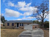 Brick ranch home with attached garage and driveway at 7024 E Constellation Dr, North Charleston, SC 29418