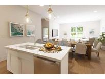 Modern kitchen island with white cabinets and quartz countertop at 7416 Indigo Palms Way, Johns Island, SC 29455