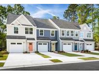 Row of charming townhouses with attached garages and modern exterior finishes at 1064 Crescent Cove Ln, Summerville, SC 29483