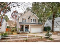 Two-story house with a white picket fence, and a charming front porch at 1581 Harborsun Dr, Charleston, SC 29412