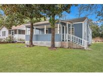 Newly painted blue house with a porch and a well-maintained lawn at 2265 Bailey Dr, North Charleston, SC 29405