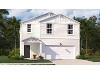 Two-story white house with a two-car garage and landscaping at 303 Tiliwa Street, Summerville, SC 29486