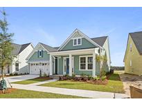 Quaint craftsman style home with light green siding and a welcoming front porch at 364 Trailmore Ln, Summerville, SC 29486