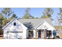 White farmhouse exterior with gray roof and a two-car garage at 42 Summer Dr, Walterboro, SC 29488