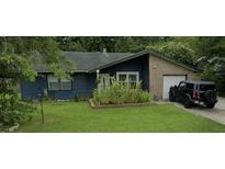 Ranch style home with blue siding, attached garage, and well-maintained lawn at 607 Mountain Pine Road, Moncks Corner, SC 29461