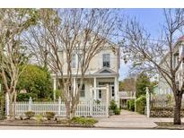 Charming yellow house with white picket fence and landscaped yard at 12 John St # Includes 8 & 10, Charleston, SC 29403