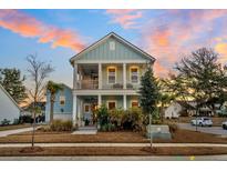 Two-story light blue house with white accents and a charming front porch at 2545 Hatch Dr, Johns Island, SC 29455