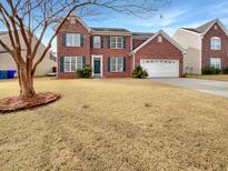 Brick two-story house with attached garage and manicured lawn at 3387 Middlesboro Ave, Summerville, SC 29485