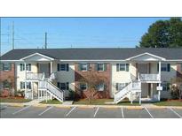 Two-story apartment building with brick and siding, featuring staircases and parking at 3930 Azalea Dr # W, North Charleston, SC 29405